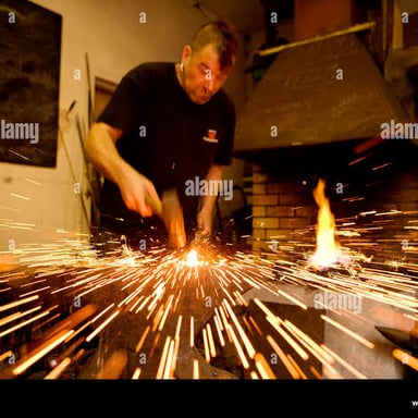 A blacksmith striking hot metal with a hammer.