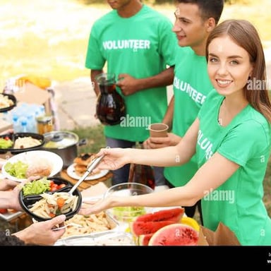 A person hands food to someone in need.