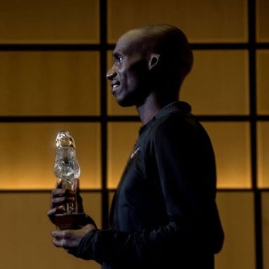 An athlete holding a trophy after setting a record.