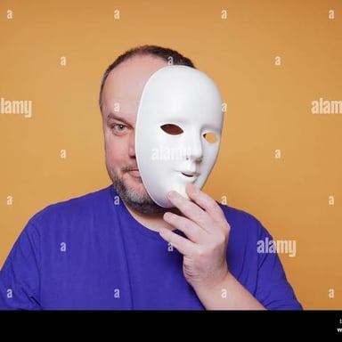 A person removing a mask to reveal their face.