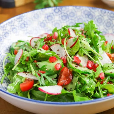 Fresh green arugula, also called rocket, arranged as salad leaves