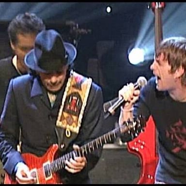 Guitarist Carlos Santana performs onstage with his guitar.