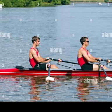 Rowers sculling a racing shell, each using two oars.