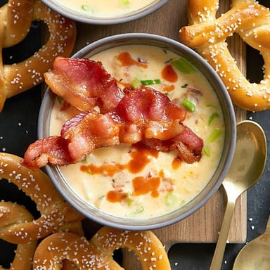 A bowl of plain soup with no visible seasoning or garnish.