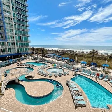 A resort beside a beach along the sea.