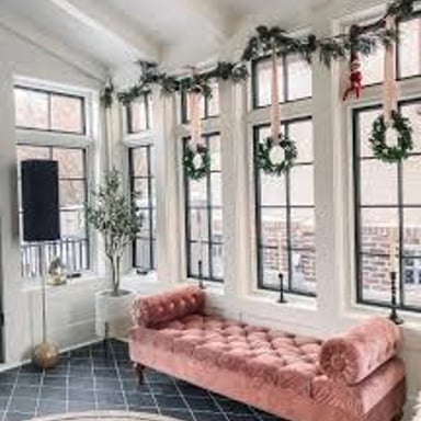 A bright room illuminated by daylight through several windows.