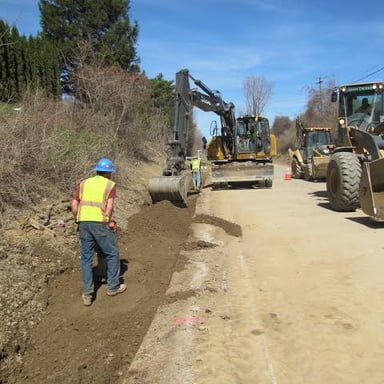 A road construction scene showing a roadway being made wider.
