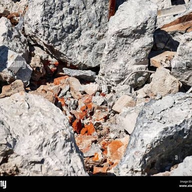 A pile of rubble and fragments at a demolition site.