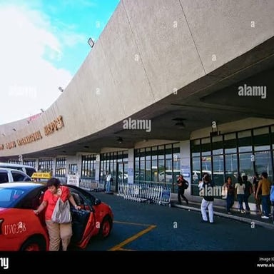 A taxi waiting outside an airport terminal