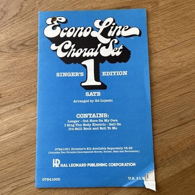 Sheet music and a songbook representing a performer's collection of songs.