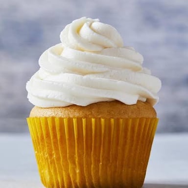 A cupcake topped with a thick layer of frosting.
