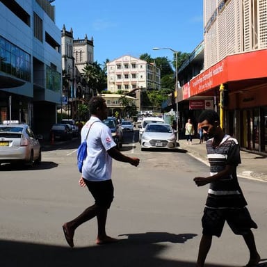 People walking along a street in Suva, Fiji.