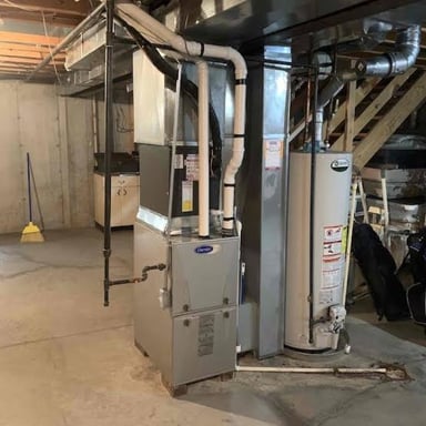 A residential furnace installed in a basement utility area.