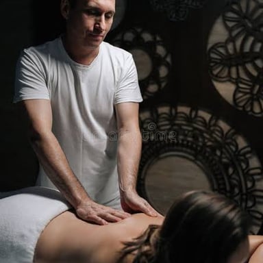 A professional masseur kneading a client's back.