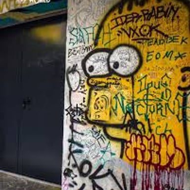 Graffiti covering and damaging the surface of a wall.