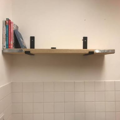A spirit level resting on an even tabletop.