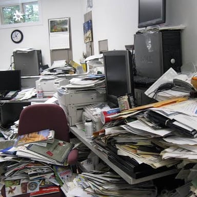 A cluttered desk showing a disorderly arrangement