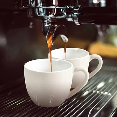 A shot of espresso served in a small cup.