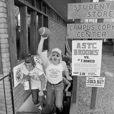 Two college leaders standing together on a campus.