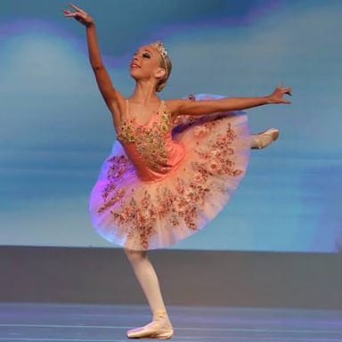 A ballet dancer wearing a short, flared tutu.