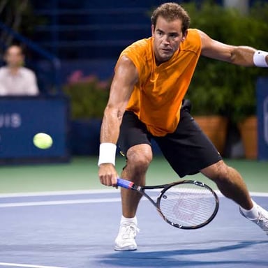 Pete Sampras playing tennis in a match.