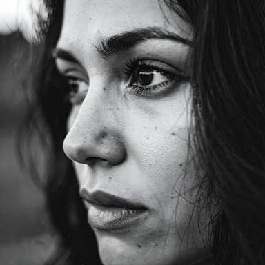 A person shown with a notably gloomy and melancholic expression.