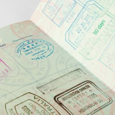 An open passport showing multiple official stamps on its pages.
