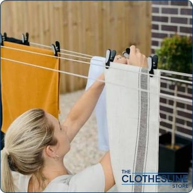 Clothes fastened with pegs to an outdoor line to dry.