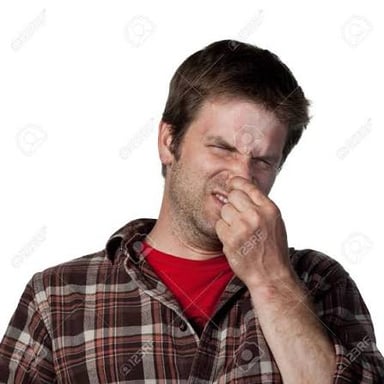 A person covering their nose in reaction to an unpleasant smell