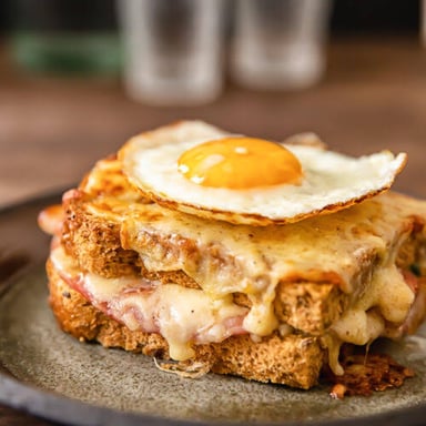 A croque madame topped with a fried egg