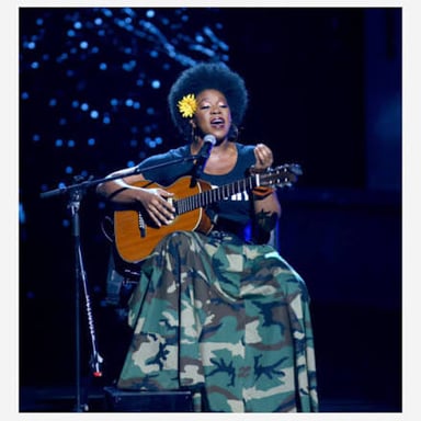 Singer India.Arie performing with an acoustic guitar