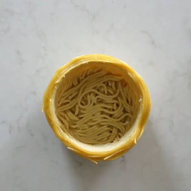 Pasta noodles, the food referenced in the “impasta” pun