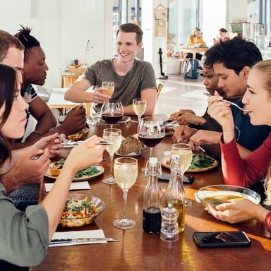 People eating a meal at tables inside a restaurant.