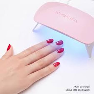 A gel manicure being cured under a nail lamp.