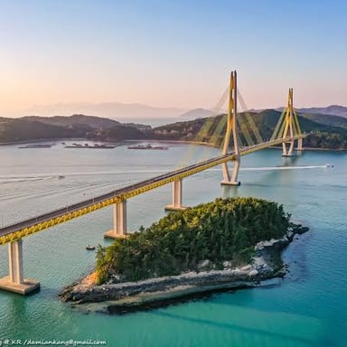 Coastal scenery on Geoje Island, South Korea, with a bridge linking the island to the mainland.