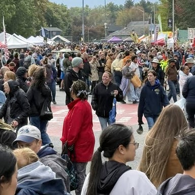 People arriving at an event, illustrating the sense of coming to attend.