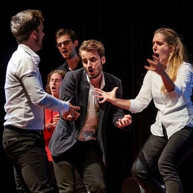 Actors performing a scene on a theater stage.