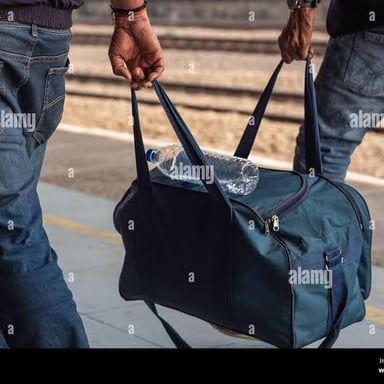 A traveler carrying a bag through an airport