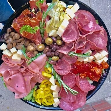 A deli counter displaying sliced cold cuts and cheeses.