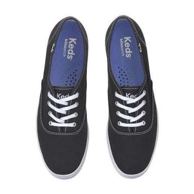A pair of low-top canvas sneakers with rubber soles, in the classic Keds style.