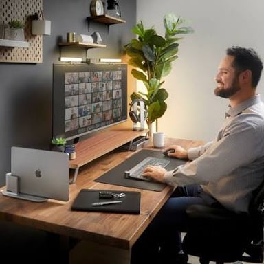 A person attending a video meeting from home on a laptop.