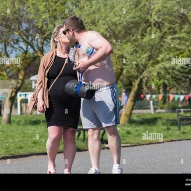A couple kissing outdoors as a public display of affection