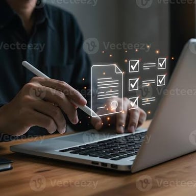 A person making revisions to a document on a laptop.