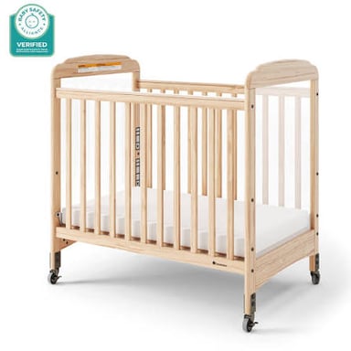 A baby crib with a mattress enclosed by raised wooden sides.