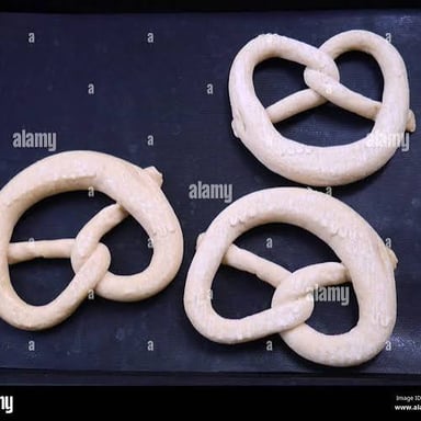 A baked pretzel formed into a looped knot shape.