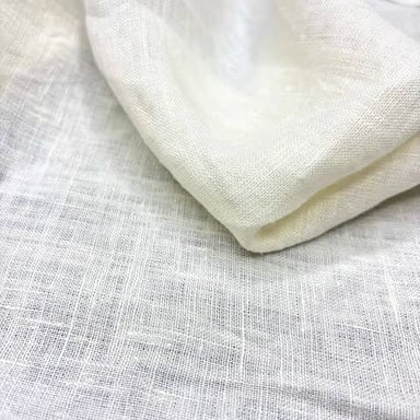 A piece of unbleached linen in a soft, pale ecru shade.