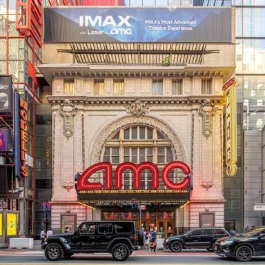 The exterior of an AMC movie theater with its name displayed above the entrance.