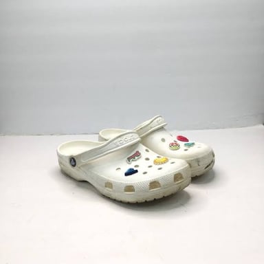 A lightweight Crocs clog showing its ventilation holes and decorative charms.