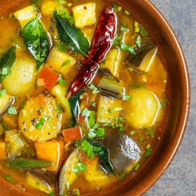 A bowl of South Indian sambar, a tangy lentil stew with vegetables