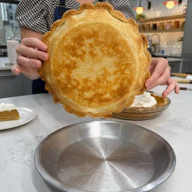 A metal pie tin holding pastry before baking.